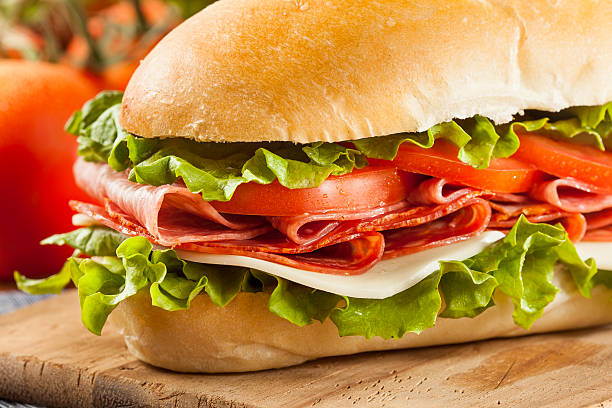 italiano casero sub sándwich - sandwich submarine delicatessen salami fotografías e imágenes de stock