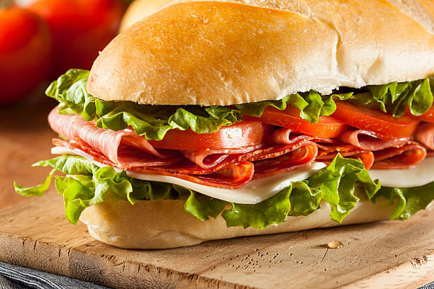 istock Close-up Italian sub hoagie sandwich cutting board stuffed 454965099