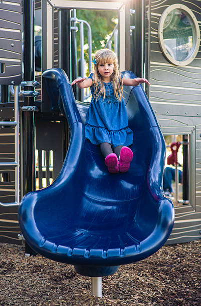 istock little girl playing on the playground 454969101