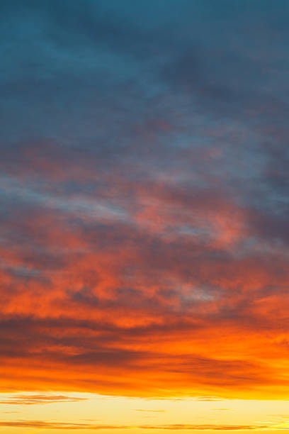 istock yellow sunrise clouds under blue morning sky 454969231