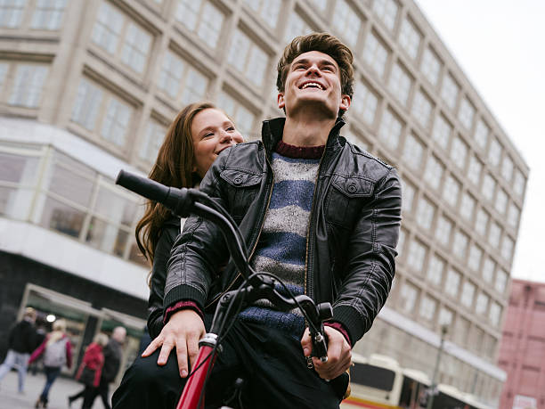 istock Young couple in love riding bicycle 454969389
