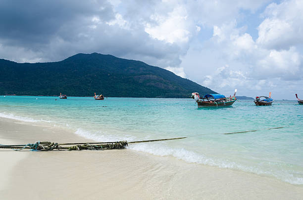 istock Many Thai traditional long tail boats on the beach 454971841