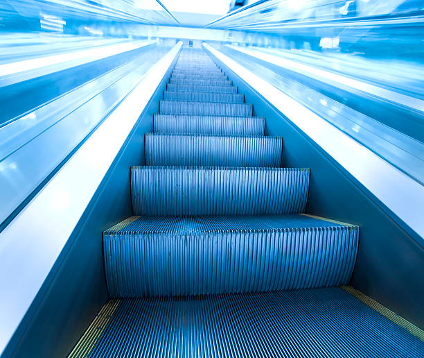 istock steps of escalator in business center 454975349