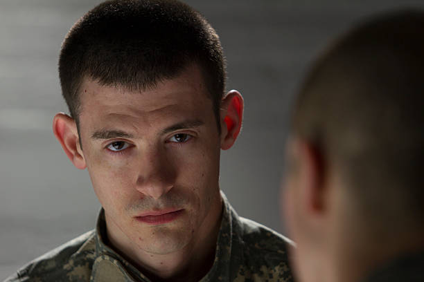 istock Soldier being counseled by peer, horizontal 454980679