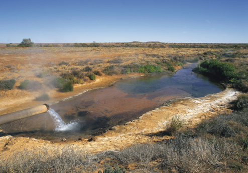 Hot water pouring from Artesian  Bore .on the Birdsville track. South Australia.