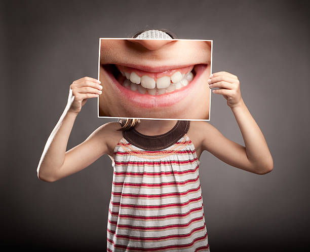 istock little girl holding a smile 454981383
