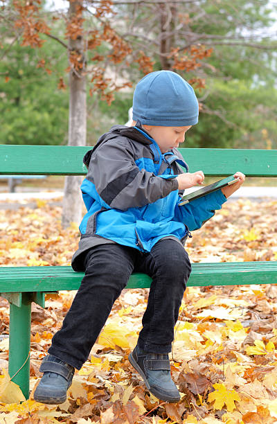 istock Cute little boy surfing on his tablet computer 454986825