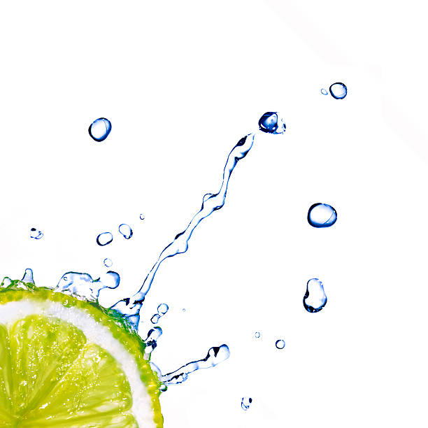 istock Slice of lime with water drops isolated on white 454991283