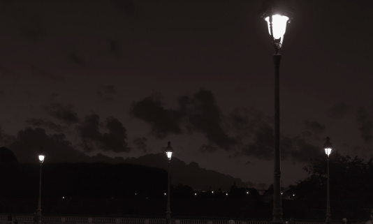 Street lights under a cloudy sky, at night