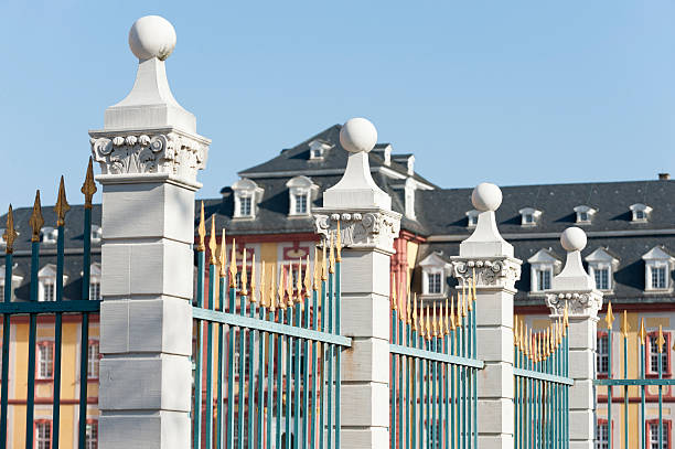 Four golden spikes, part of a fence.