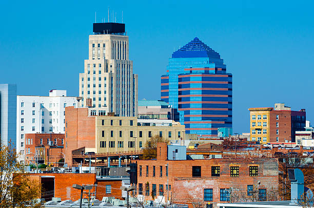 Durham, NC skyline Durham, NC skyline with the Hill building on the left and Durham Centre on the right.  Durham is part of the Raleigh-Durham-Chapel Hill metropolitan area, also known as the Research Triangle. dyrham stock pictures, royalty-free photos & images