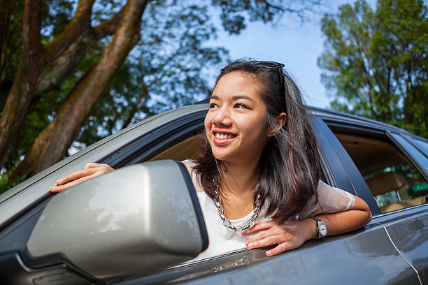 istock Happy attractive woman in car 454994681