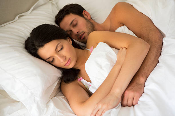istock Young couple asleep together 454995433