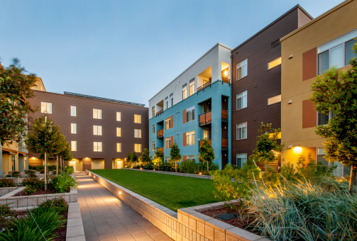 Modern apartment building at dusk.