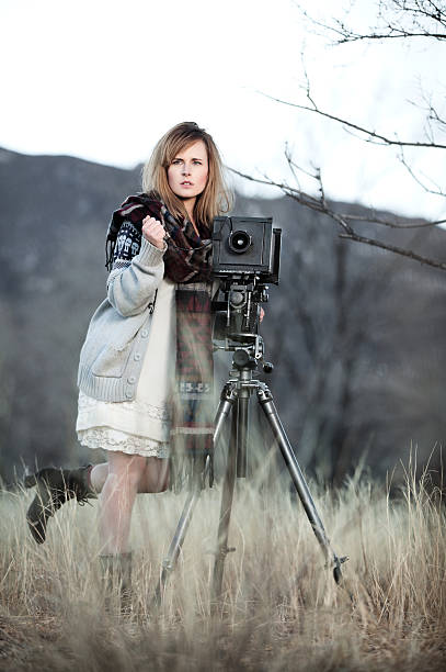 istock Young Woman with Vintage Bellow Camera 454996339