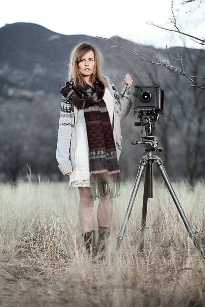 istock Young Woman with Vintage Bellow Camera 454996521