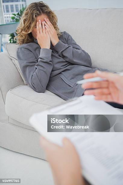 Upset Patient Crying On Couch Stock Photo - Download Image Now - 30-39 Years, Adult, Advice