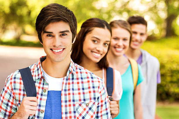 istock Male Student With Classmates Standing In A Row On Campus 455002201