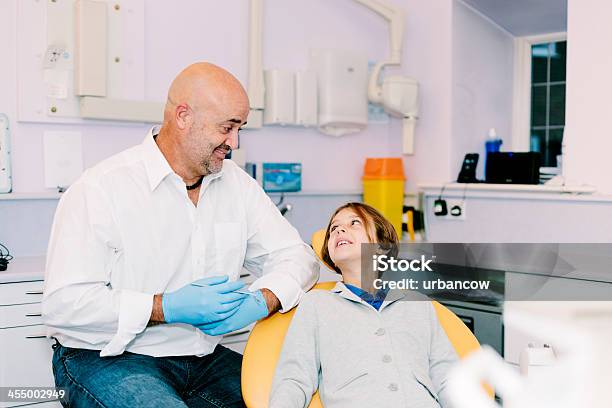 Dentist And Smiling Patient Stock Photo - Download Image Now - Adult, Chair, Cheerful