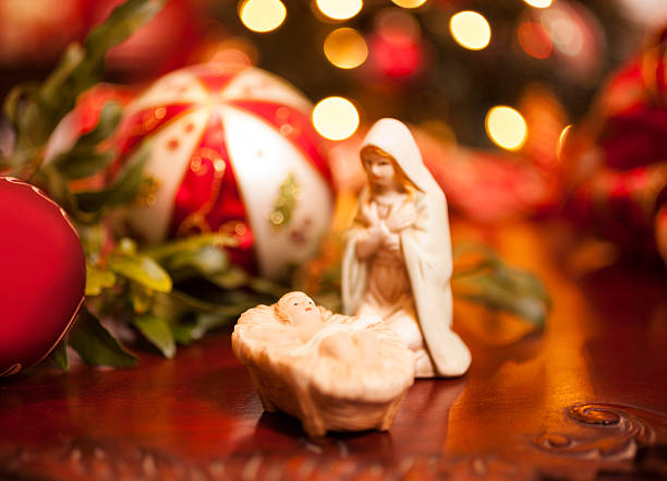 istock Christmas: Close-up of nativity scene.  Lighted tree background. 455003831