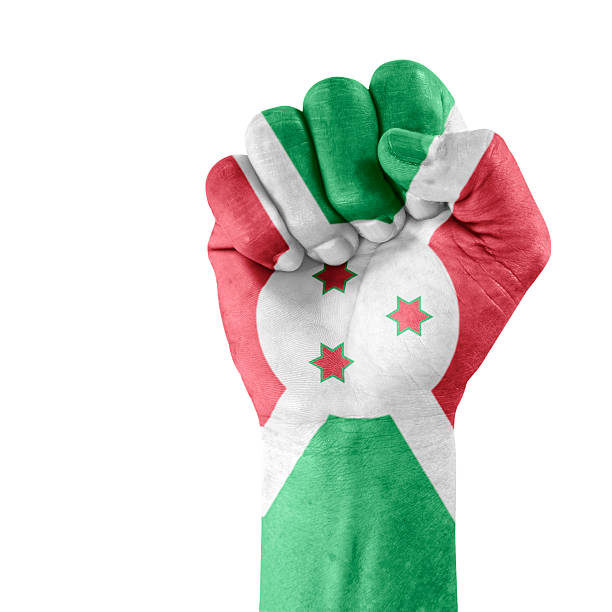 Flag of Burundi on hand with clenched fist gesture over white background..