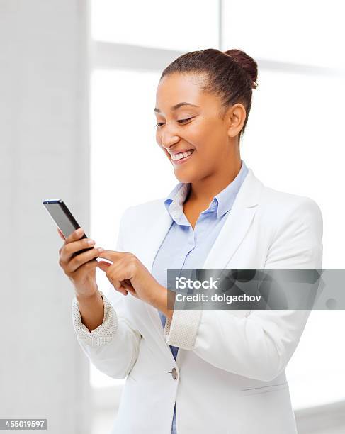African Businesswoman With Smartphone In Office Stock Photo - Download Image Now - Adult, African Ethnicity, African-American Ethnicity