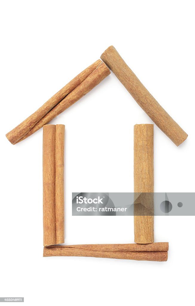 Cinnamon sticks and shape of house. White background Five cinnamon sticks and shape of house. Isolated on white background Abstract Stock Photo