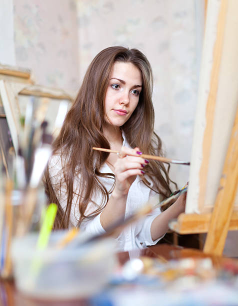 istock girl paints in workshop 455050463