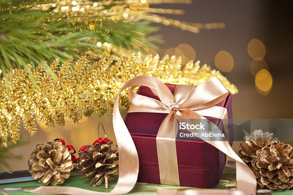 elegant gift box on defocused lights background Christmas present piled underneath a christmas tree. At The Edge Of Stock Photo