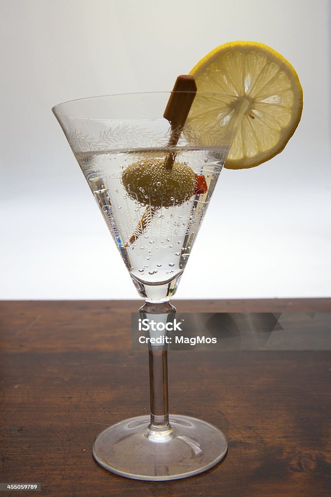 Drink with olive in a high glass Drink with olive in a high glass on a dark bar Alcohol - Drink Stock Photo