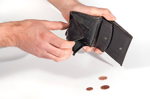 istock Man hands holding an empty wallet and some euro coins 455074757