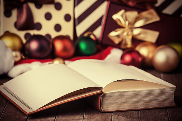 istock An open book surrounded by Christmas gifts 455075439