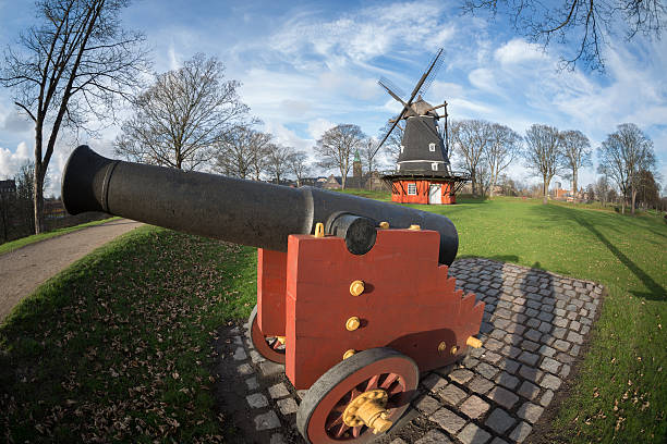 istock Cannon and windmill in Copenhagen Citadel - Kastellet 455111983