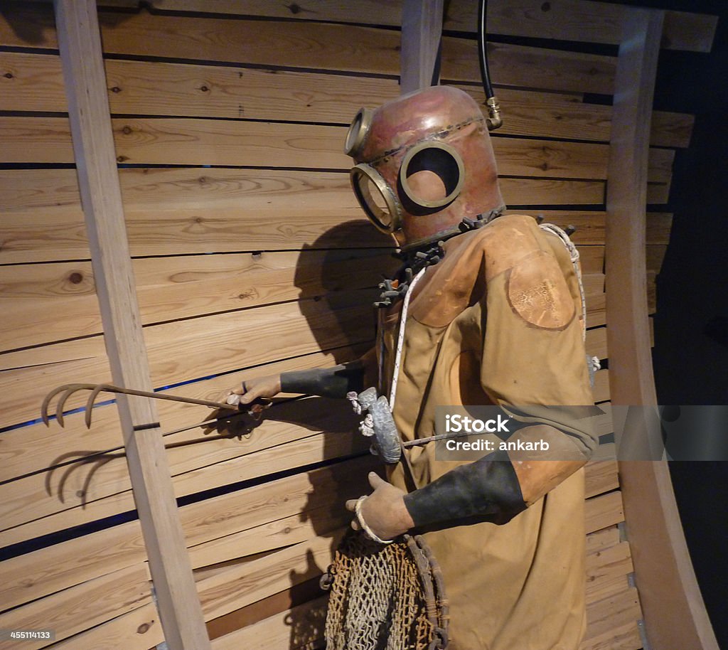 Diver in helmet and suit Old diver in helmet and suit Diving Helmet Stock Photo