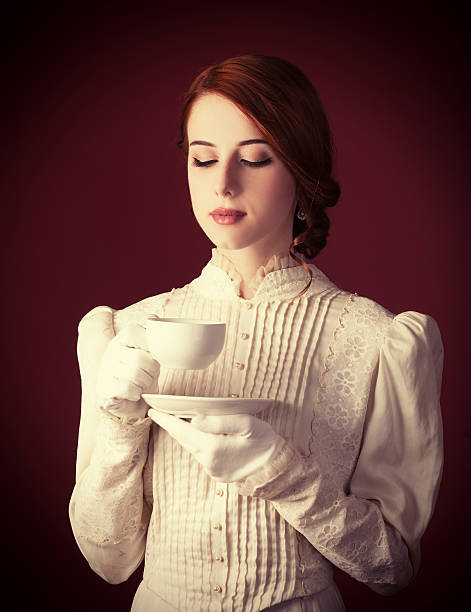 istock Beautiful redhead women with cup of tea 455164283