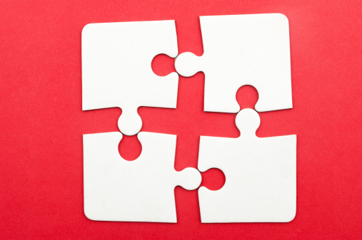 Group of white paper jigsaw puzzles