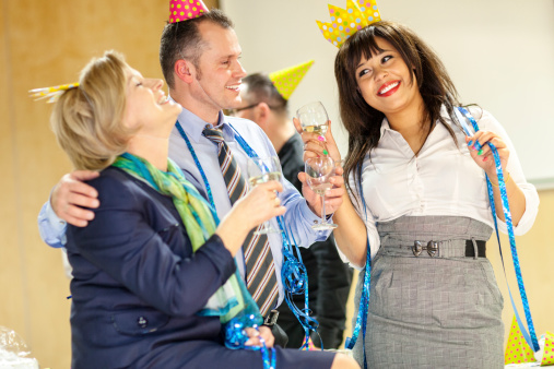 Business people celebrating New Year's Eve at the office.