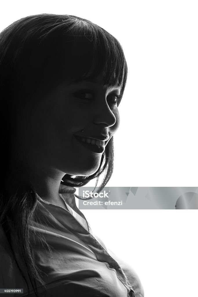 Profile Of Smiling Woman A side profile of a smiling young woman's face. Isolated on white background. Studio Shot Stock Photo