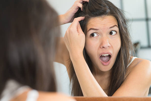 istock Horrified young woman looking in the mirror 455197315