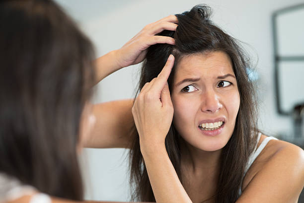 istock Horrified young woman looking in the mirror 455197325