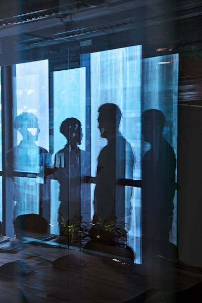 istock Reflection of two businessmen talking in the office 455204597