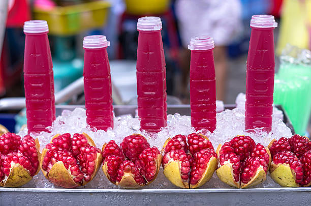istock Ripe pomegranate fruit and water in bottle 455241251