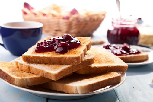 Breakfast with bread toast with cherry jam and a cup of cocoa