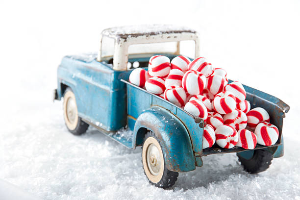 istock Toy truck carrying striped peppermint candy 455247253