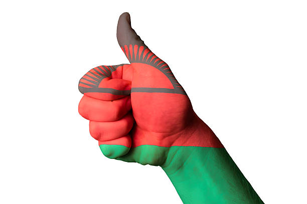 Hand with thumb up gesture in colored malawi national flag as symbol of excellence, achievement, good, - for tourism and touristic advertising, positive political, cultural, social management of country