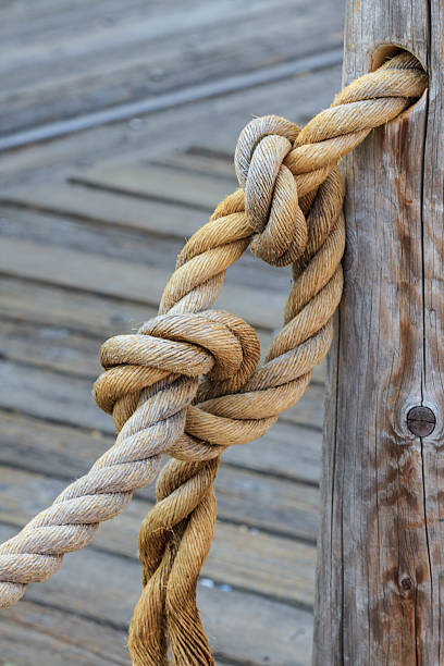 istock Rope and knot attached to wooden pole 455265713
