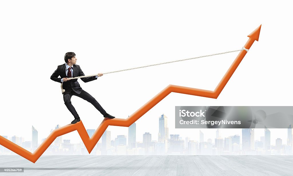 Growth concept Image of businessman standing on graph and pulling it upwards Achievement Stock Photo