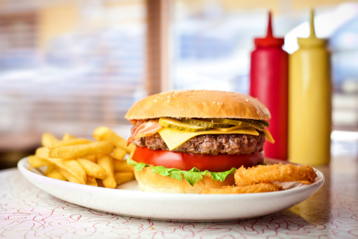 Close up of the fresh hamburger with french fries.