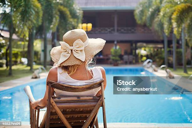 A Woman Sunbathing By The Pool Stock Photo - Download Image Now - Beach, Lobby, Summer