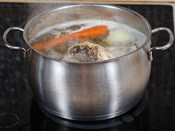 istock simmering chicken soup in pot on cooker close up 455276419